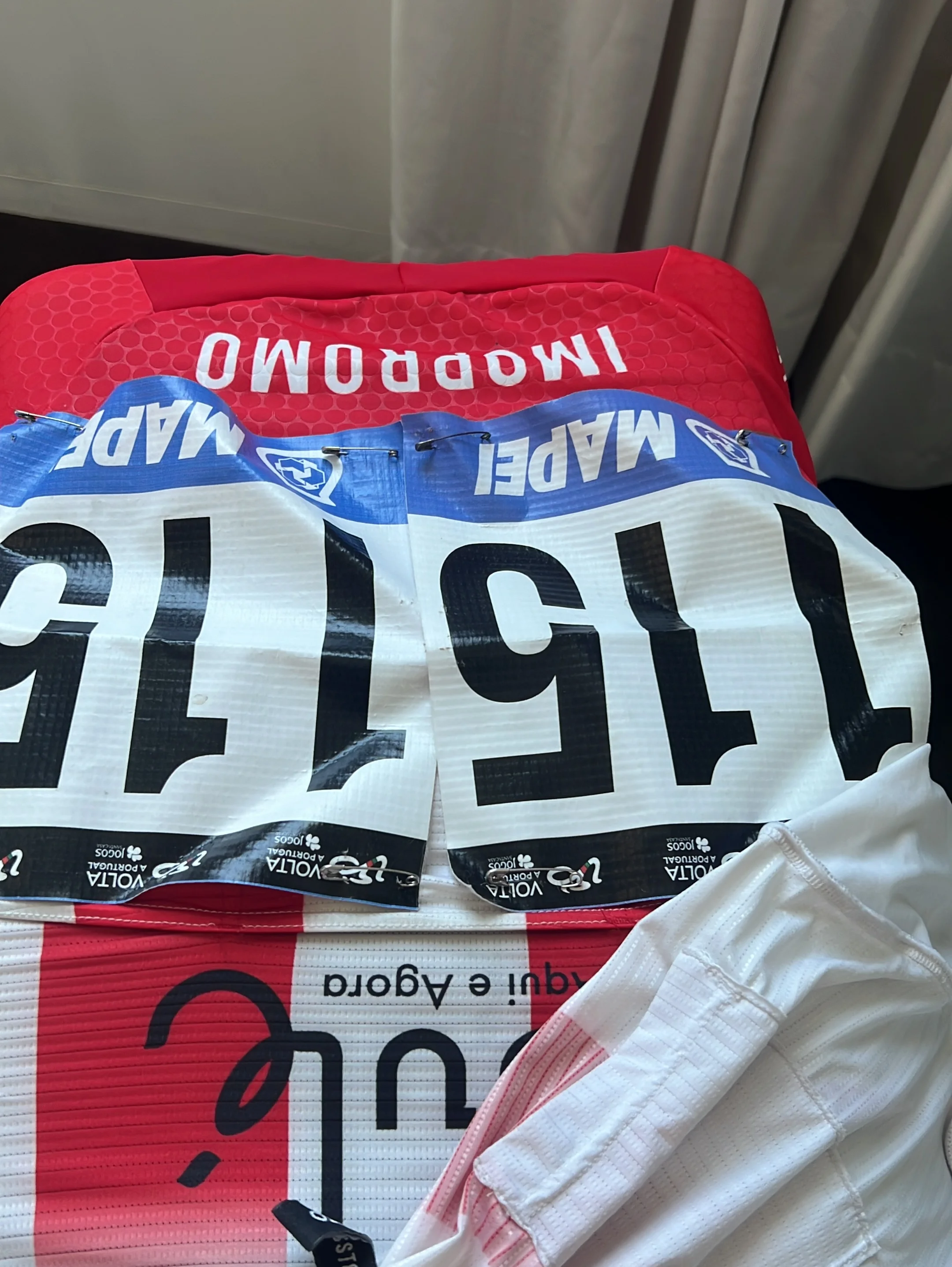 Race bib #115, official Volta a Portugal branding