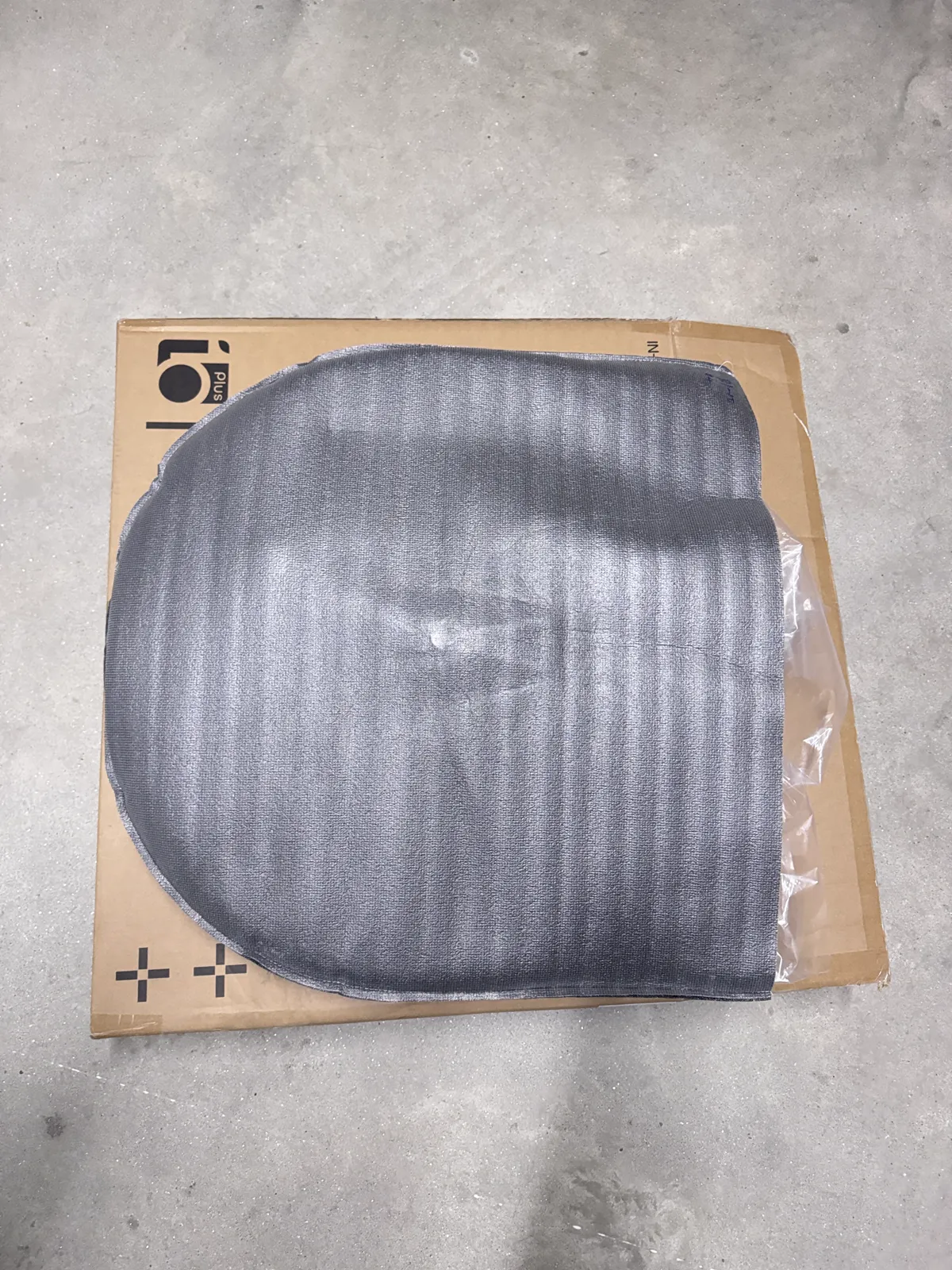 Opened 10PLUS box with a grey foam cover over the wheel